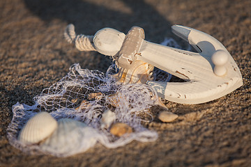 Image showing sailing boat and seashell in sand decoration closeup