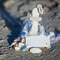 Image showing sailing boat and seashell in sand decoration closeup