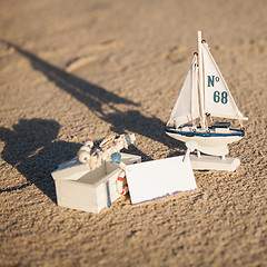 Image showing sailing boat and seashell in sand decoration closeup