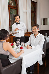 Image showing young smiling couple at the restaurant 
