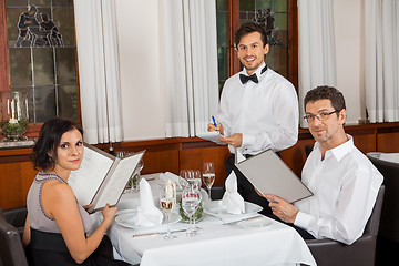 Image showing young smiling couple at the restaurant 