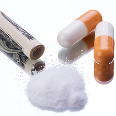 Image showing illegal pharmaceutical pills and drugs money on mirror