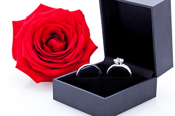 Image showing Engagement ring with a bunch of red roses