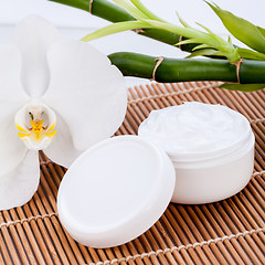 Image showing cosmetic face cream on wooden background 