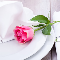 Image showing Table setting with a single pink rose