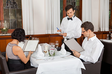 Image showing young smiling couple at the restaurant 