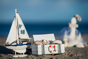 Image showing sailing boat and seashell in sand decoration closeup