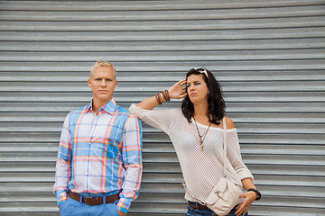 Image showing Fashionable couple posing in front of a metal door