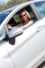 Image showing young attractive happy woman sitting in car summertime