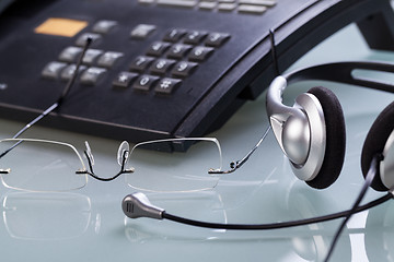 Image showing working place office desk table headset glasses telephone