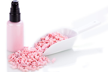 Image showing pink body lotion in dispenser and aroma salt isolated