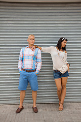 Image showing Fashionable couple posing in front of a metal door
