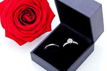 Image showing Engagement ring with a bunch of red roses