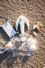 Image showing sailing boat and seashell in sand decoration closeup