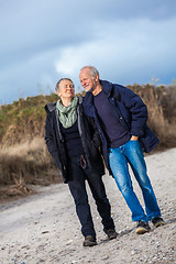 Image showing happy elderly senior couple walking on beach