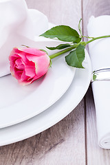 Image showing Table setting with a single pink rose