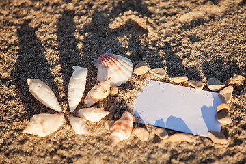 Image showing sailing boat and seashell in sand decoration closeup