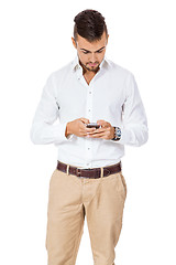 Image showing Handsome man reading a message on his mobile