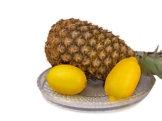 Image showing Pineapple and lemons on a platter on a white background.