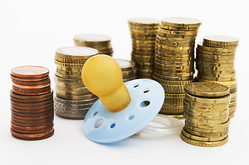 Image showing pacifier with hard money in background