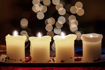 Image showing Burning candle with christmas tree bokeh