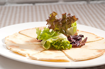 Image showing garlic pita bread pizza with salad on top