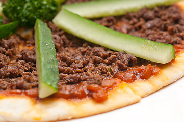 Image showing Turkish beef pizza with cucumber on top