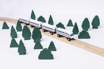 Image showing fast train driving through small forest