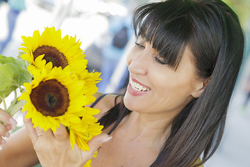 Image showing Pretty Italian Woman Looking at Sunflowers at Market