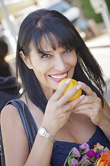 Image showing Pretty Italian Woman Smelling Oranges at the Street Market