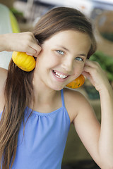 Image showing Pretty Young Girl Having Fun with the Pumpkins at Market