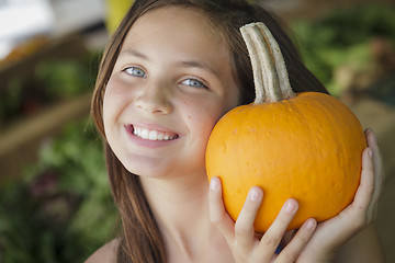 Image showing Pretty Young Girl Having Fun with the Pumpkins at Market