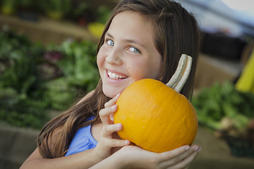 Image showing Pretty Young Girl Having Fun with the Pumpkins at Market