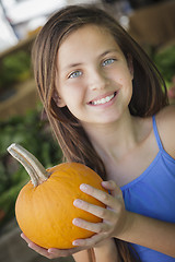 Image showing Pretty Young Girl Having Fun with the Pumpkins at Market