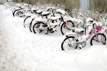 Image showing Bicycles covered with snow 