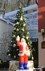 Image showing Santa Claus standing near a Christmas tree