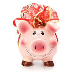 Image showing Christmas deposit concept. Piggy bank with festive bow isolated 