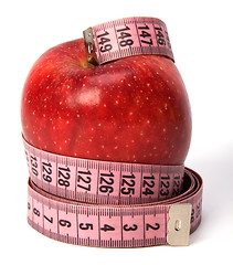 Image showing  tape measure wrapped around the apple isolated on white backgro