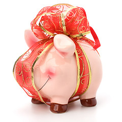 Image showing Christmas deposit concept. Piggy bank with festive bow isolated 