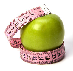 Image showing  tape measure wrapped around the apple isolated on white backgro