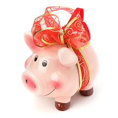 Image showing Christmas deposit concept. Piggy bank with festive bow isolated 