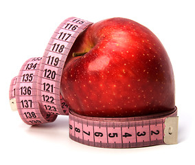 Image showing  tape measure wrapped around the apple isolated on white backgro