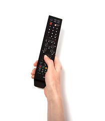 Image showing Hand holding tv remote control isolated on white background 