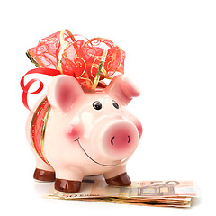 Image showing Christmas deposit concept. Piggy bank with festive bow isolated 