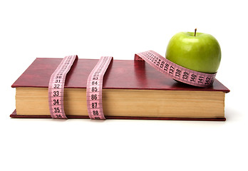 Image showing tape measure wrapped around book isolated on white background