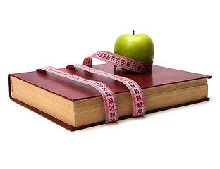 Image showing tape measure wrapped around book isolated on white background