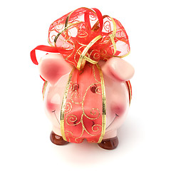 Image showing Christmas deposit concept. Piggy bank with festive bow isolated 