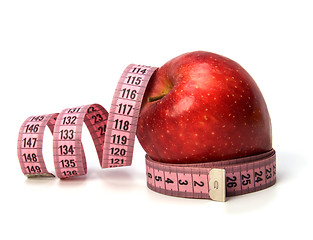 Image showing  tape measure wrapped around the apple isolated on white backgro