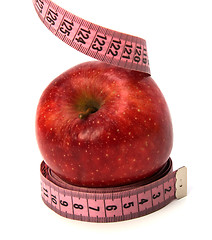 Image showing  tape measure wrapped around the apple isolated on white backgro