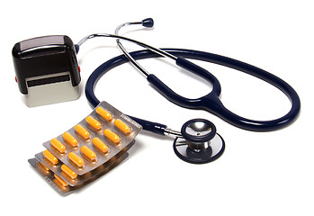 Image showing stethoscope, tablets  and doctor seal isolated on white backgrou